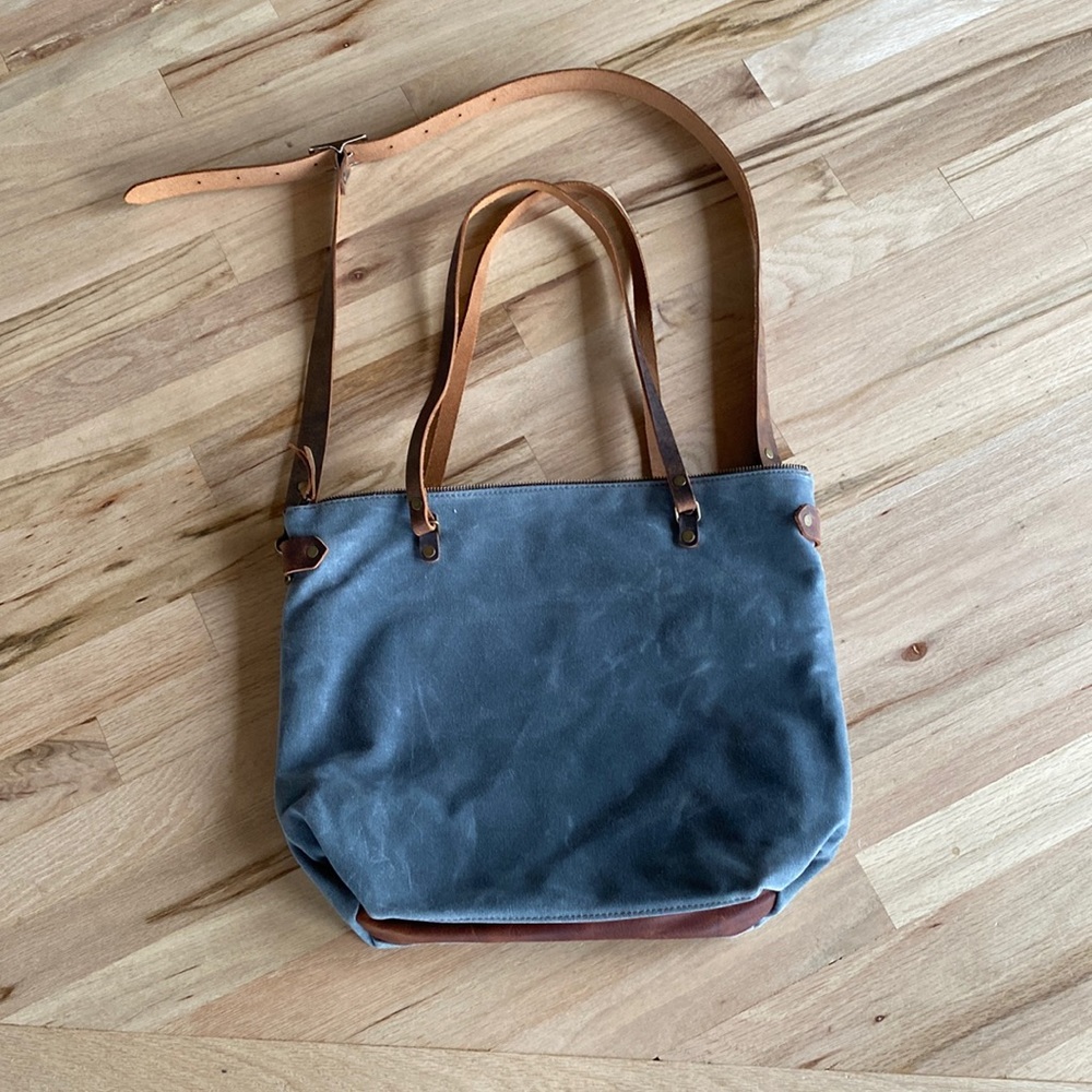 In blue waxed canvas tote bag